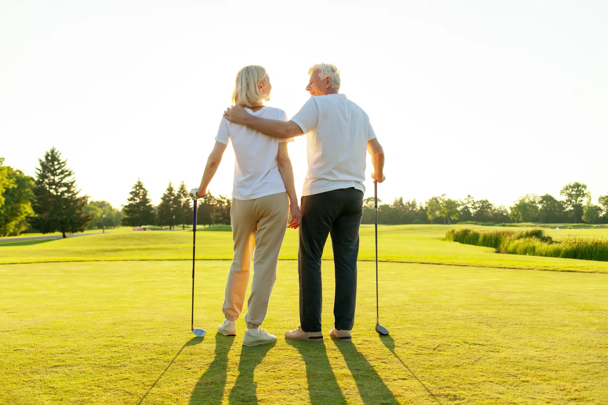 Senior couple on a golf course again after the man had recovered from shoulder replacement surgery