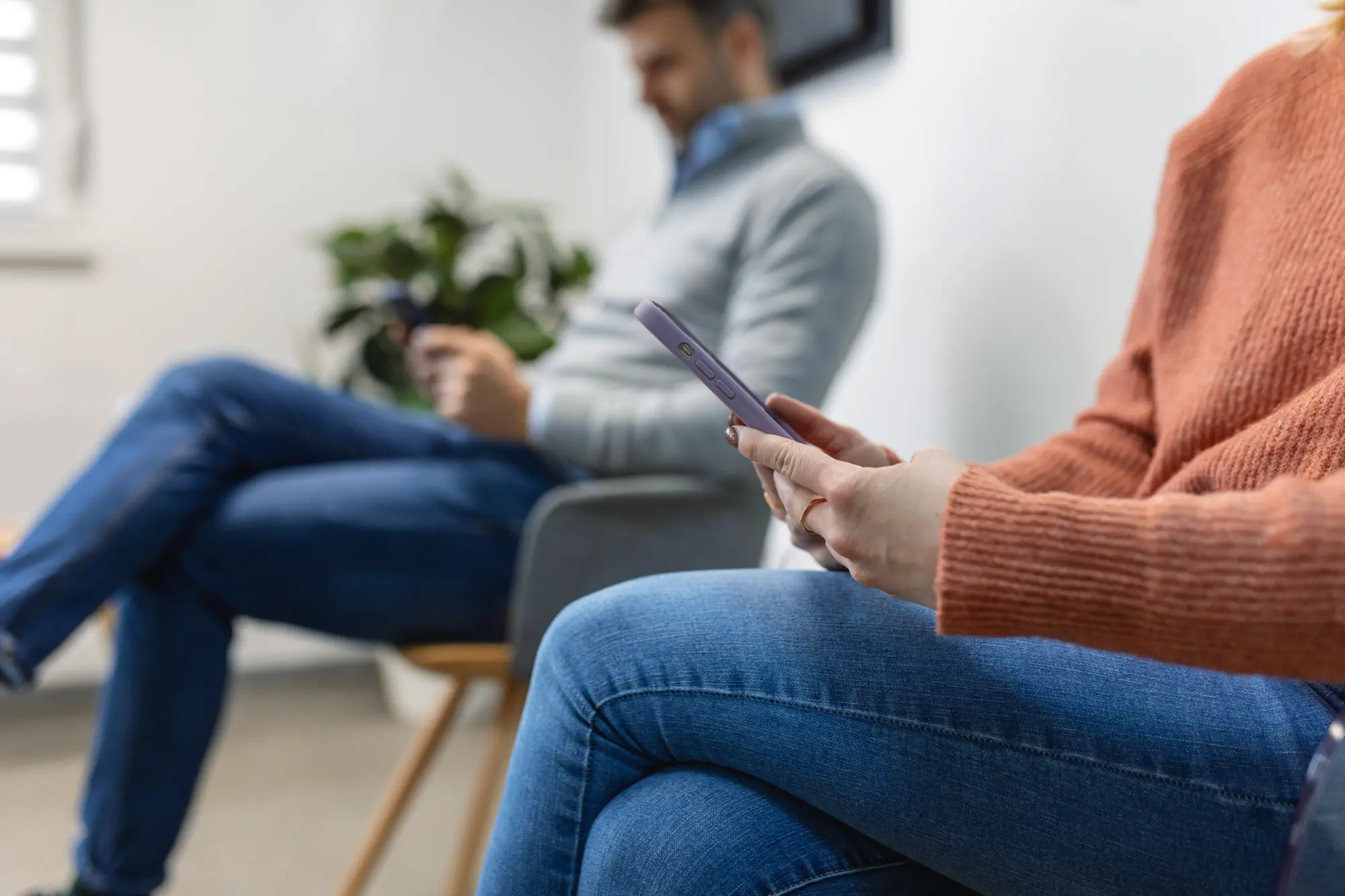 Woman on the phone in a waiting room while a family member is having shoulder replacement