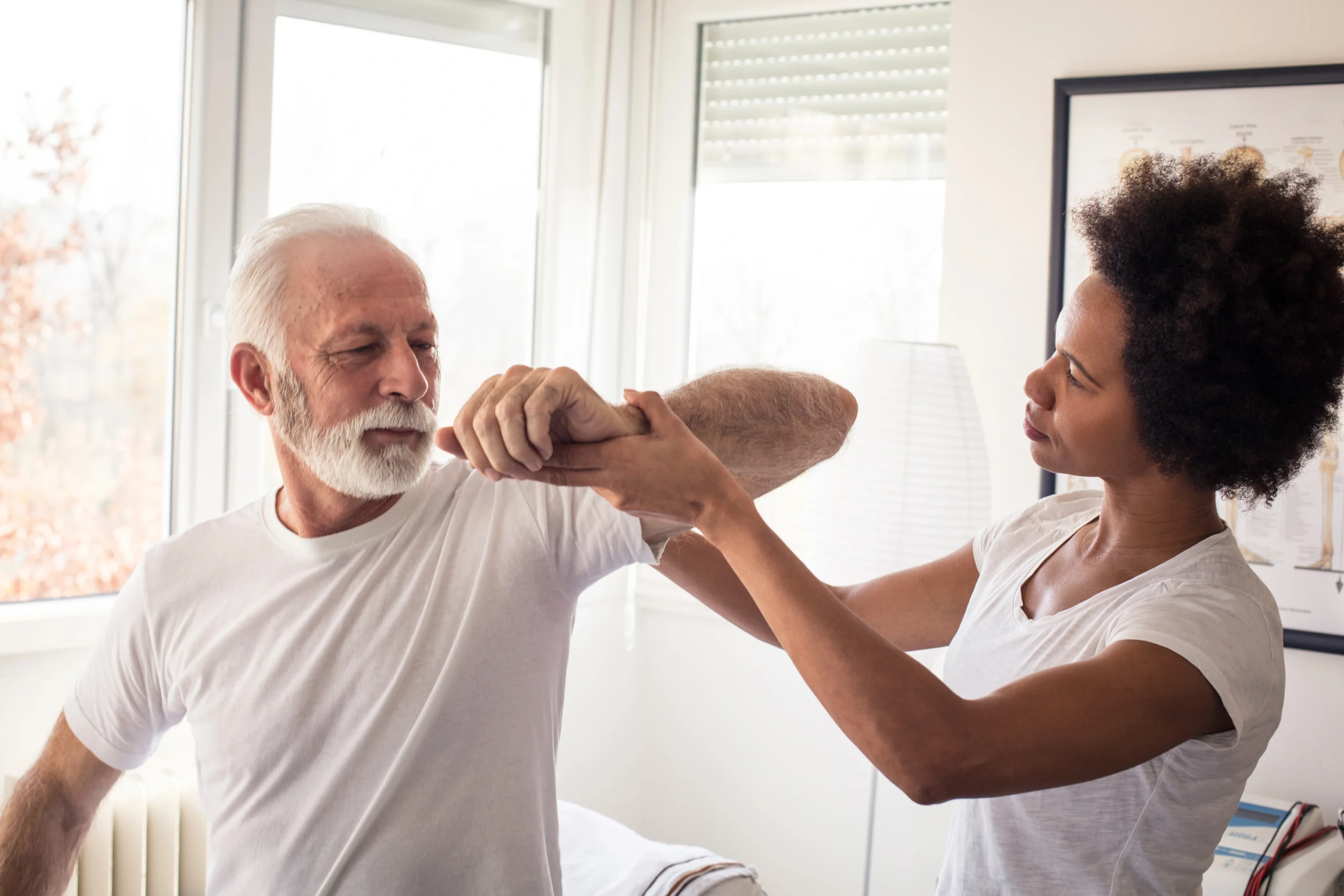 senior patient discussing with doctor what to wear after shoulder surgery.