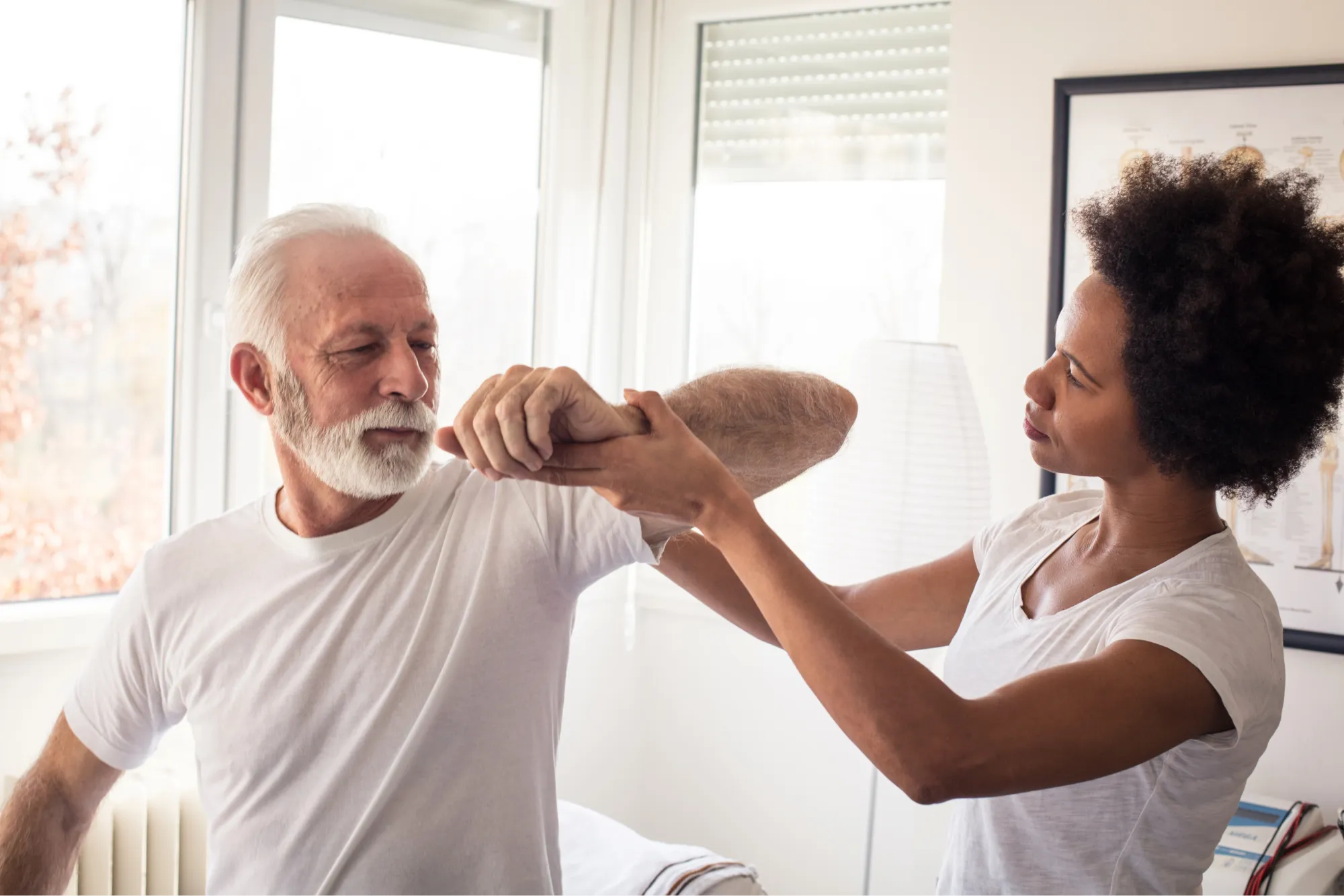 senior patient discussing with doctor what to wear after shoulder surgery.
